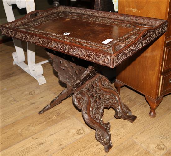 A Chinese carved tray on folding stand